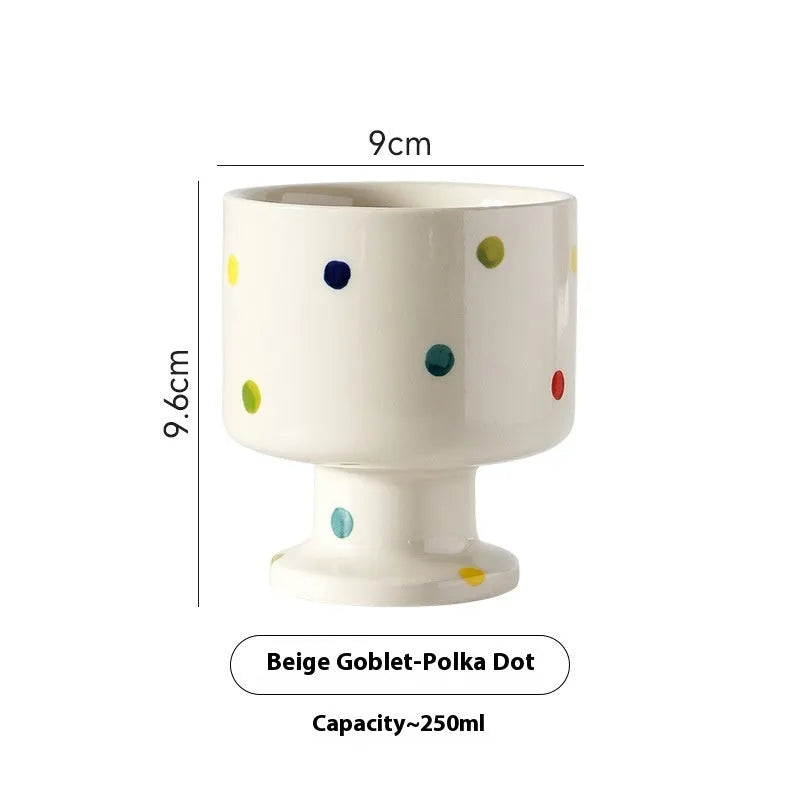 Hand-pinched irregularly shaped ceramic mug in a solid colour, shown on a table.