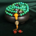 Natural raw turquoise bracelet with 108 round 8mm beads on a wrist, showing polished stone and national style design.