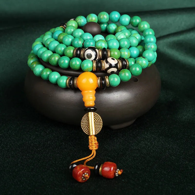 Natural raw turquoise bracelet with 108 round 8mm beads on a wrist, showing polished stone and national style design.