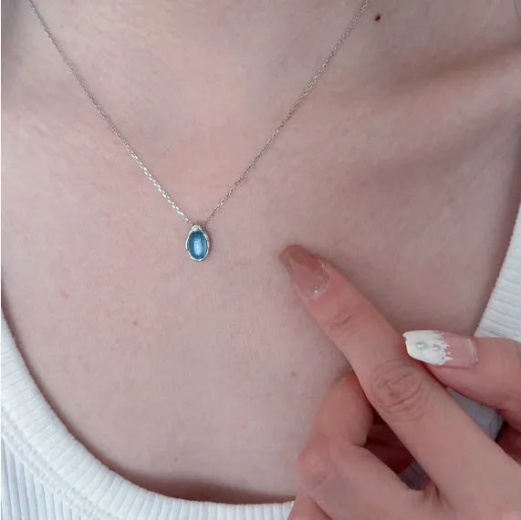 Navy blue water drop geometric pendant necklace with cross chain on white background