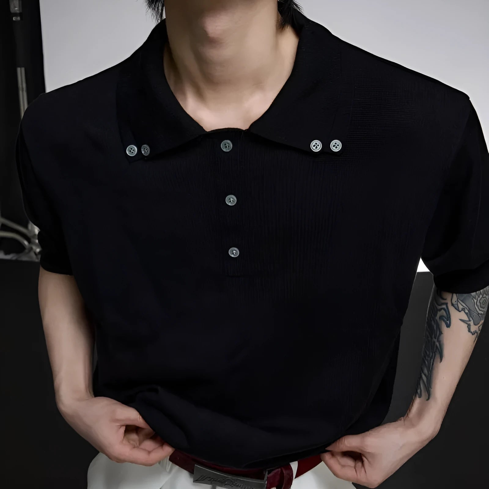 Man wearing a grey short sleeve shirt with a distinctive double collar lapel design.