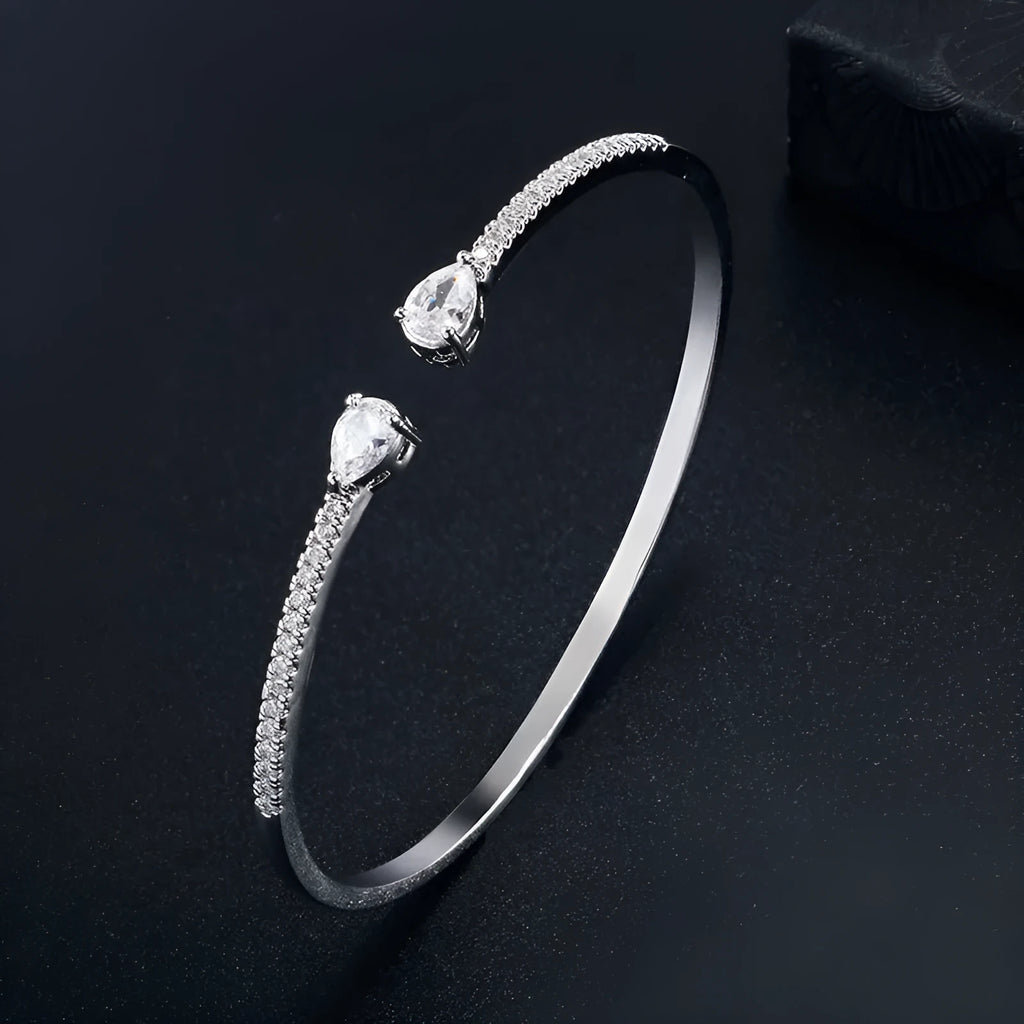Copper bracelet with multi-zircon inlay in simple style, shown in white and blue colour options.