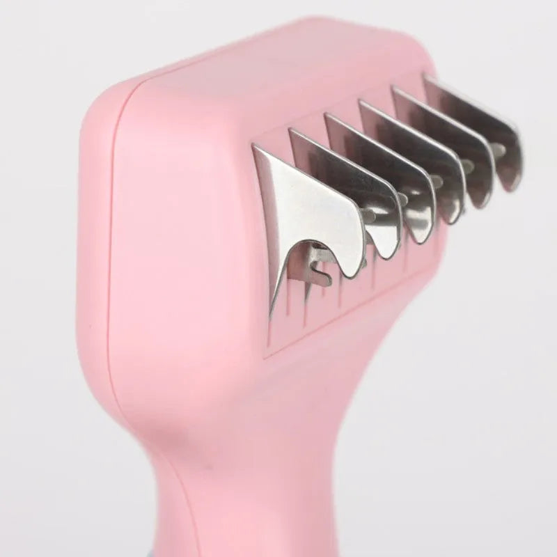 Pink stainless steel dog grooming comb with knot knife and massage pins on a white background.