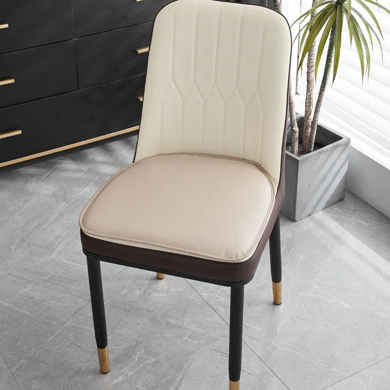 Leather horseshoe-shaped seat cushion in beige colour on a wooden chair, showing non-slip base