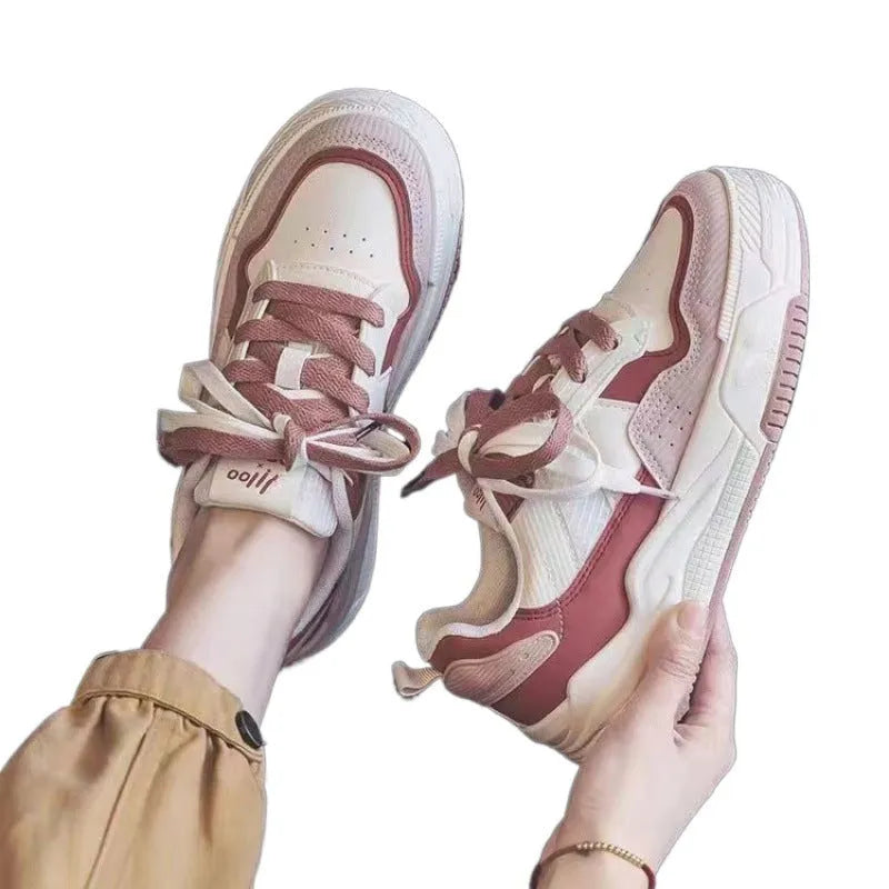 Pink and beige low-top sneakers with rubber soles and height-increasing design