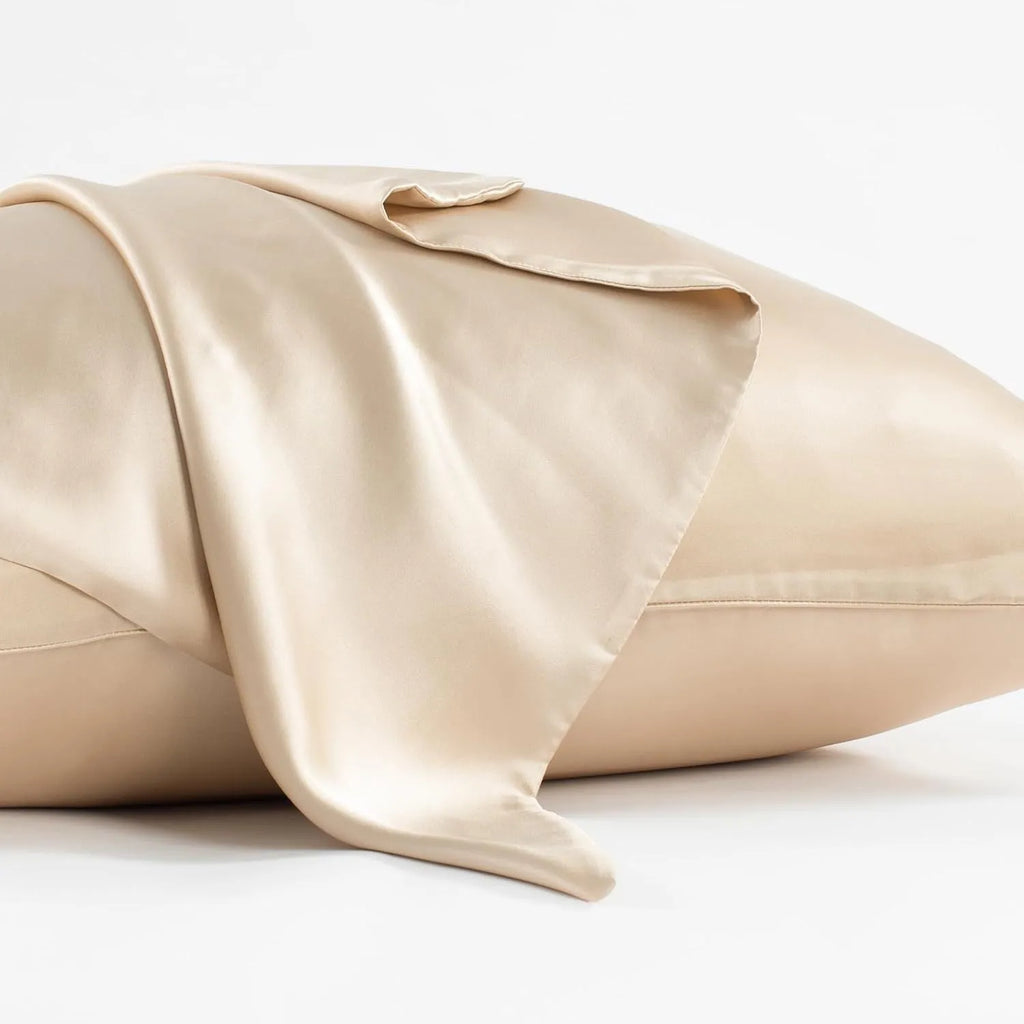 Solid colour mulberry silk envelope pillowcase in dark grey on a bed.