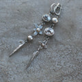 A pair of long geometric XINGX pendant earrings in antique silver with rhinestones.