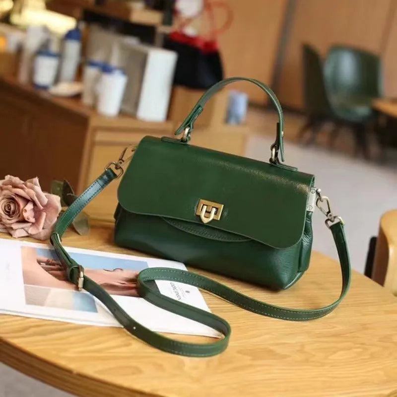 Women's dark brown genuine leather saddle back handbag with multiple compartments and shoulder straps