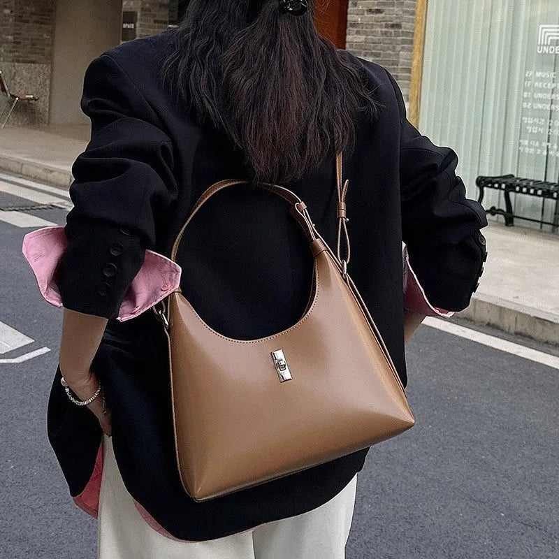 Genuine leather dumpling-shaped crossbody bag in apricot colour with an outer sandwich pocket