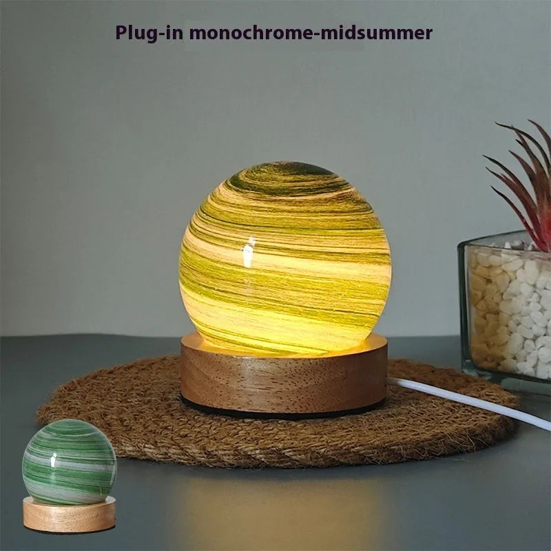 Planet night light with USB cable and base in modern simple design showing spherical shape