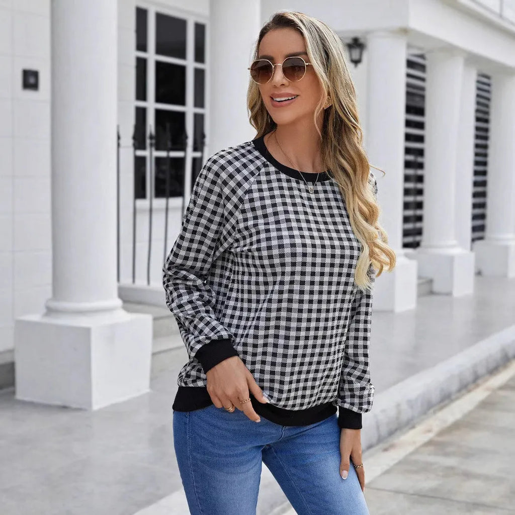 Black long sleeve pullover sweater with plaid pattern and printing detail showing front view