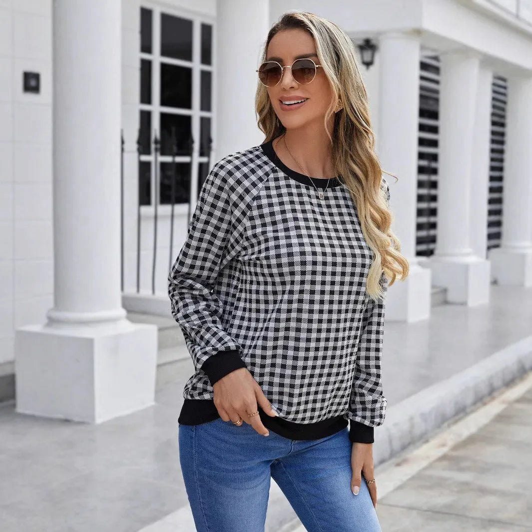 Black long sleeve pullover sweater with plaid pattern and printing detail showing front view