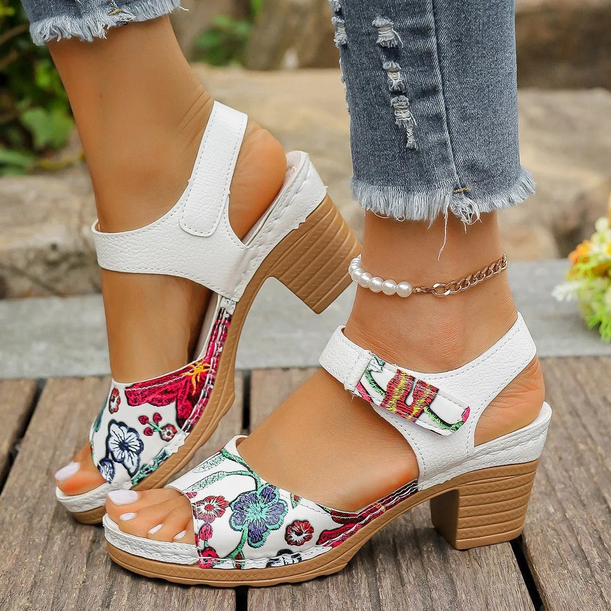 White women's high heel sandals with a visible Velcro strap buckle on a rubber sole.
