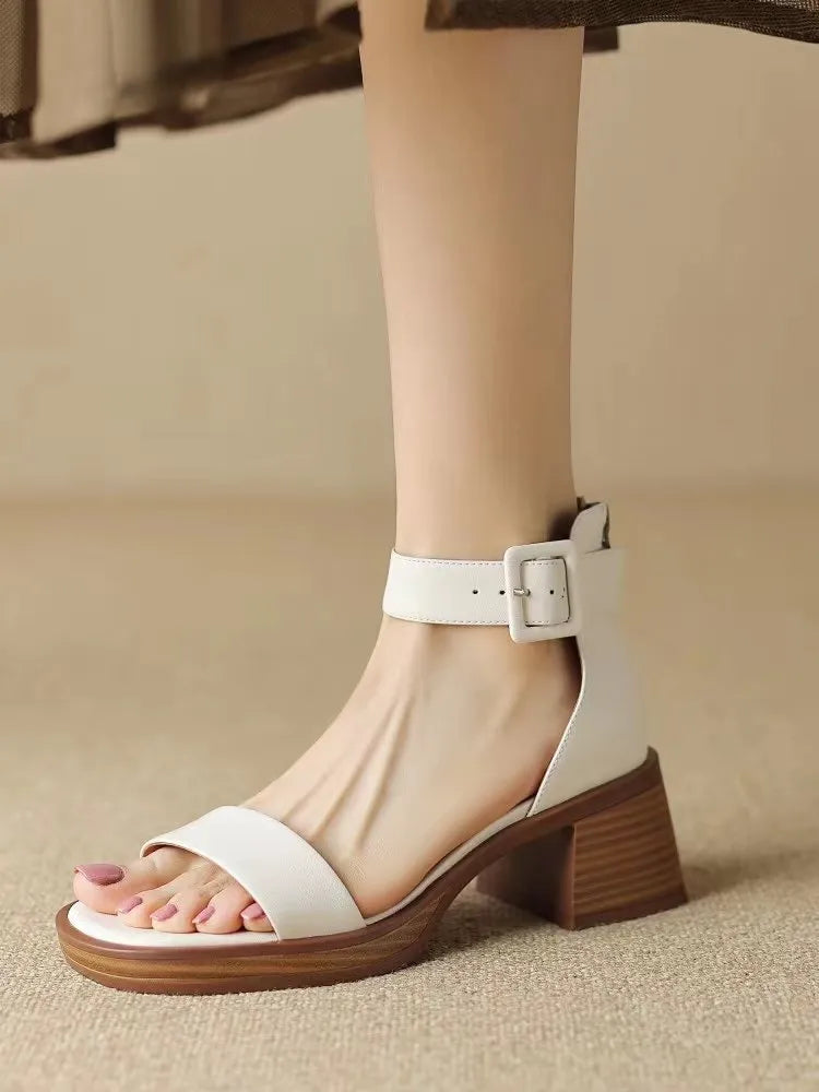 Women's white retro platform high heels with an ankle strap, shown from the side.
