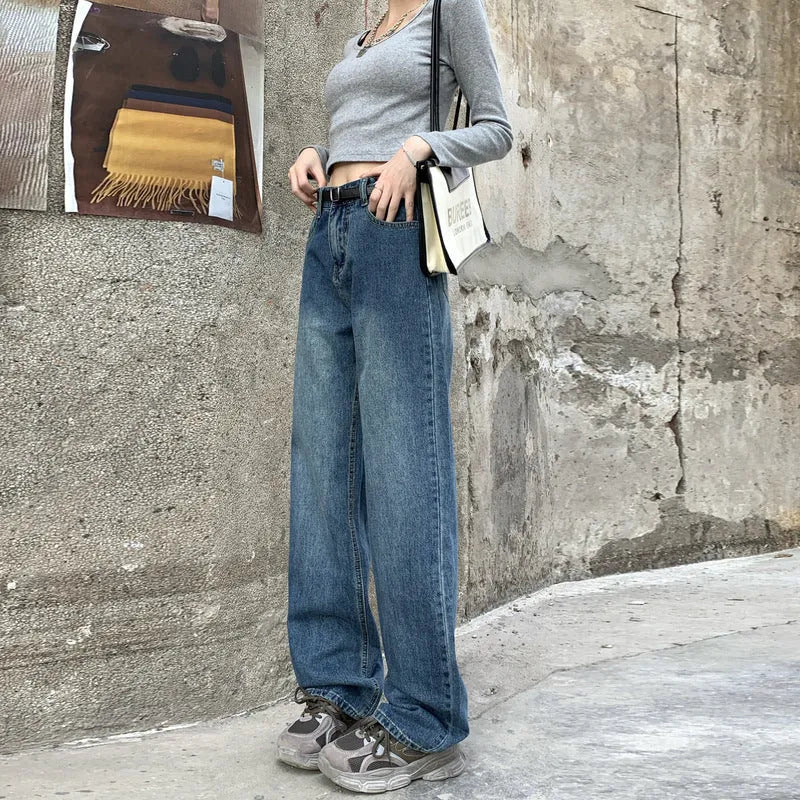 A pair of women's retro blue high-waisted straight-leg jeans laid flat, showcasing the classic five-pocket design.