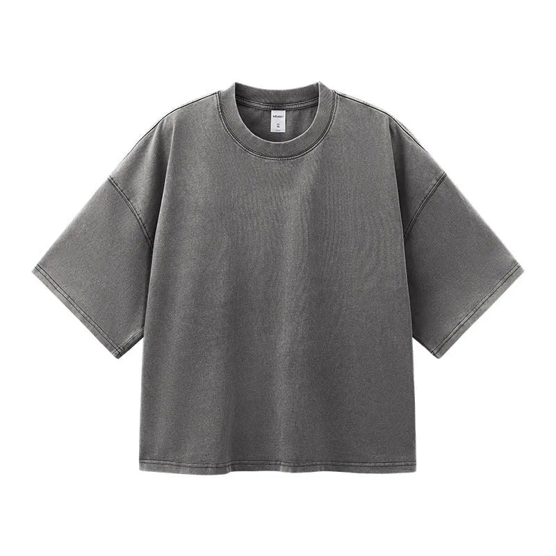 Men's vintage-style light khaki cotton t-shirt with a loose fit and drop-shoulder sleeves on a hanger.
