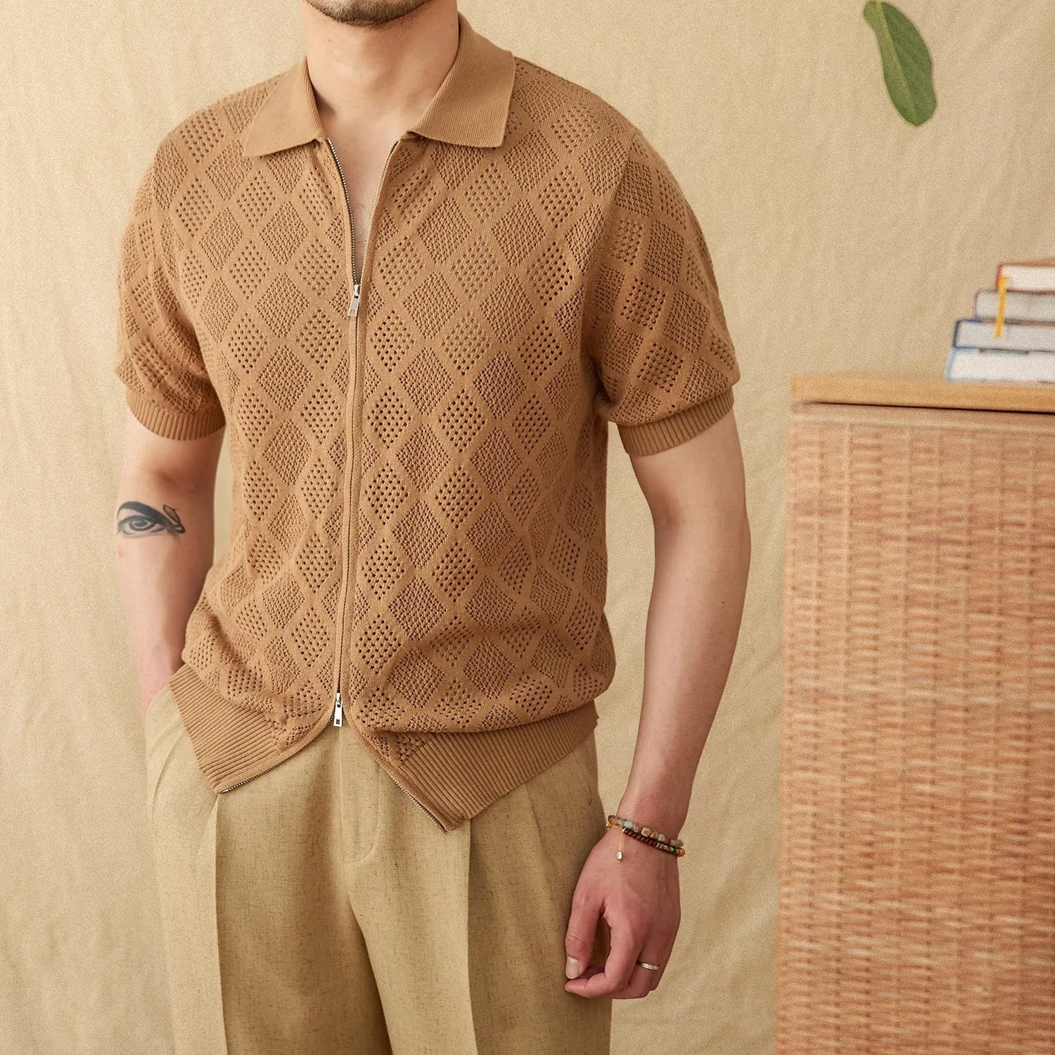 Light brown cotton short sleeve cardigan with zip front and lapel collar on a hanger