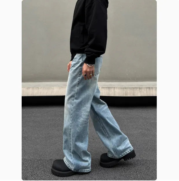 Men's blue straight leg jeans with whisker wash detail and wide leg flare