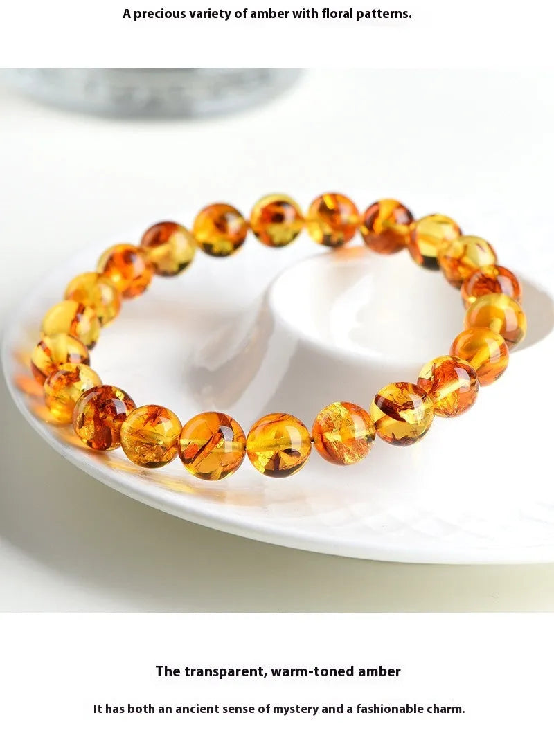 Yellow piebald amber bracelet with geometric beads showing natural flower spot patterning