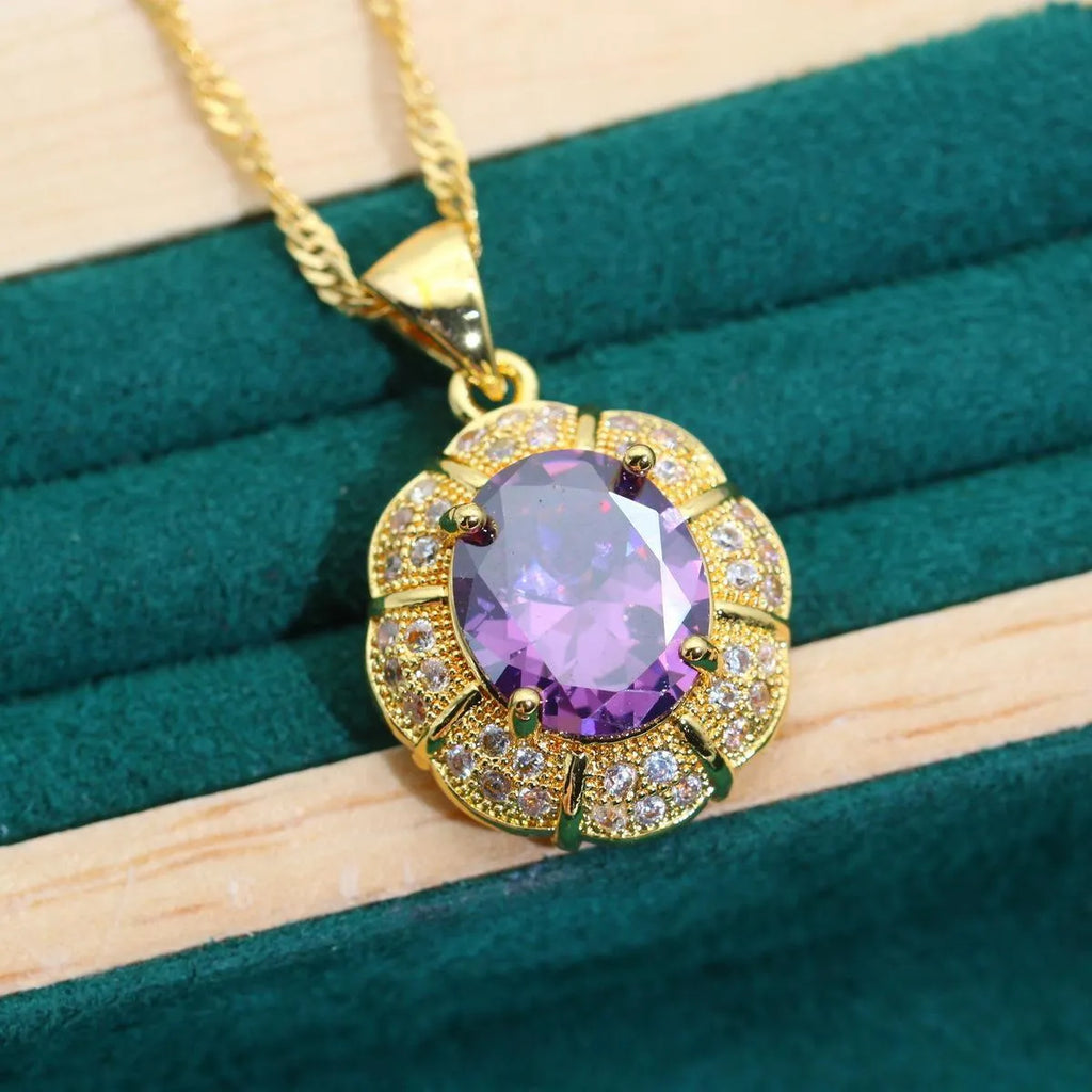 Gold plated jewellery set with blue cubic zirconia stones, showing necklace, earrings, ring, and bracelet.