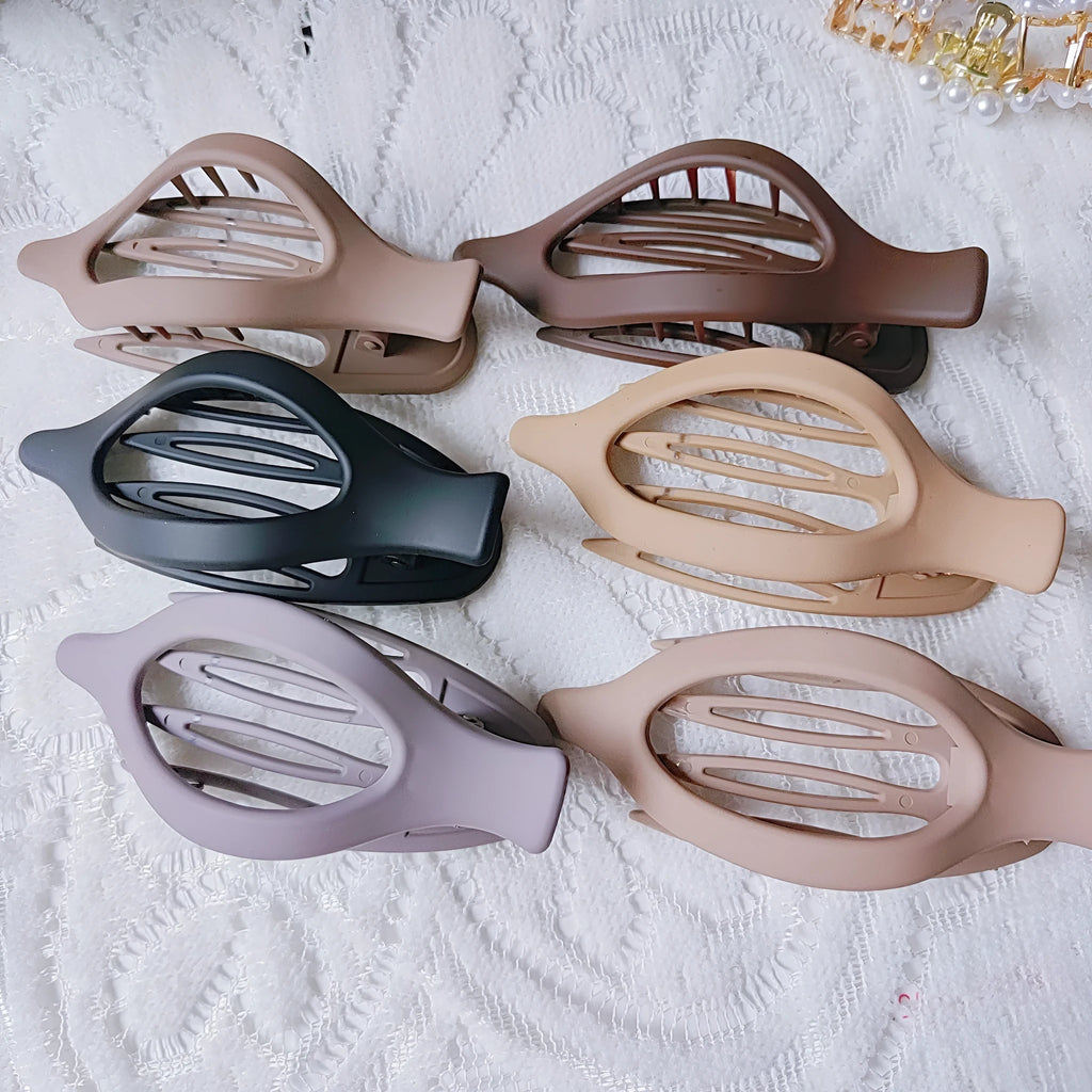 Set of six nude-coloured plastic hair clips with frosted grip finish and quadrilateral shape