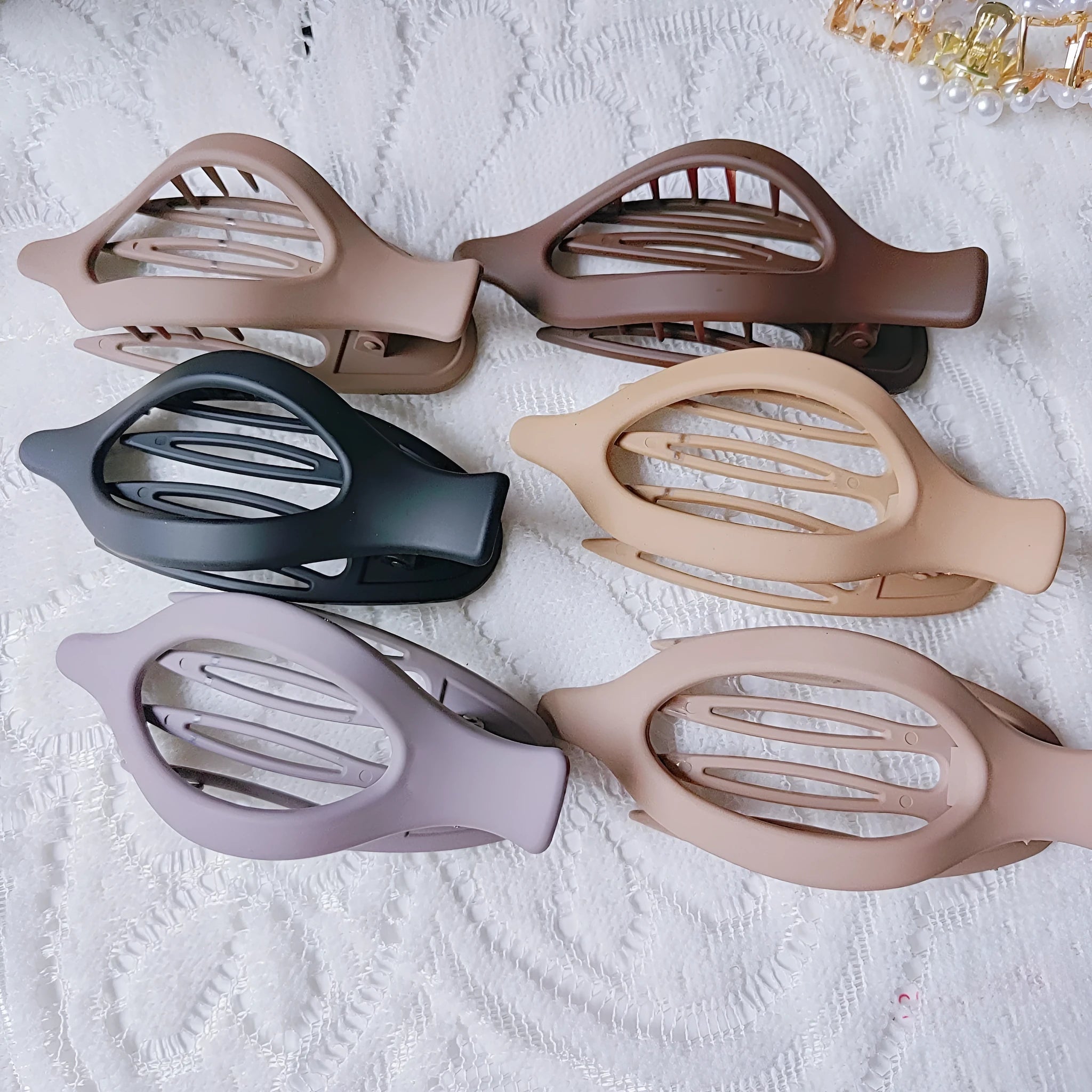 Set of six nude-coloured plastic hair clips with frosted grip finish and quadrilateral shape