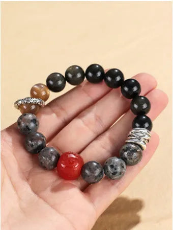Gold obsidian flame stone red agate Wukong unisex bracelet on display showing natural stone beads
