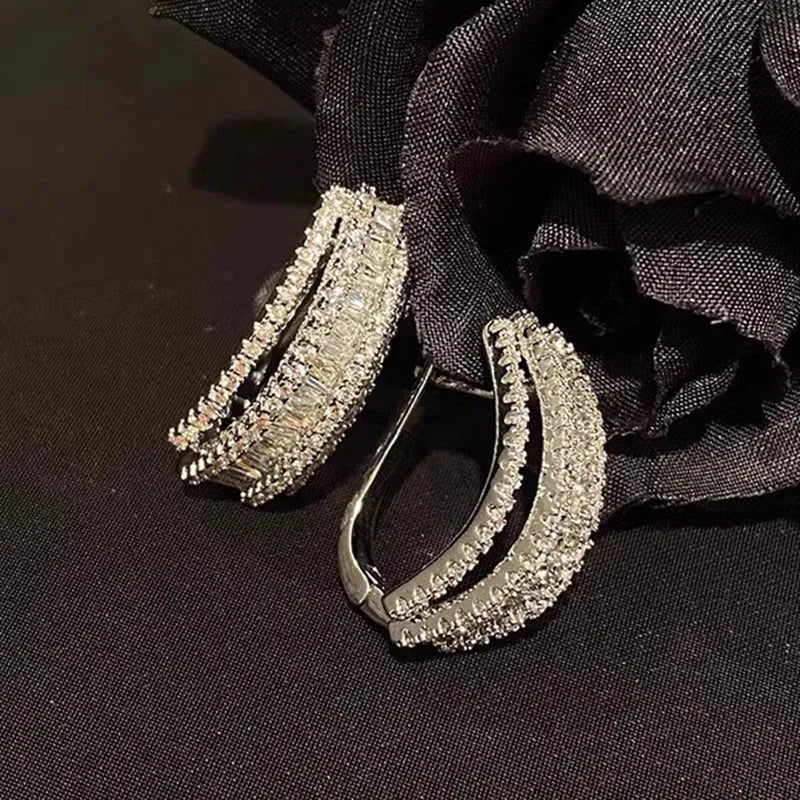 Geometric stud earrings with inlaid zircon stones in white gold colour