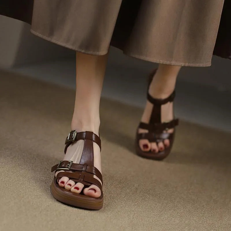 Black retro women's platform sandals with a T-buckle fastening and chunky heel.