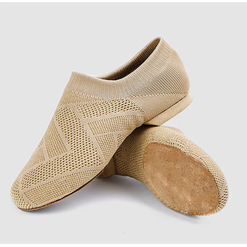 Camel coloured Latin dance shoes with cotton mesh upper and leather sole on a plain background.