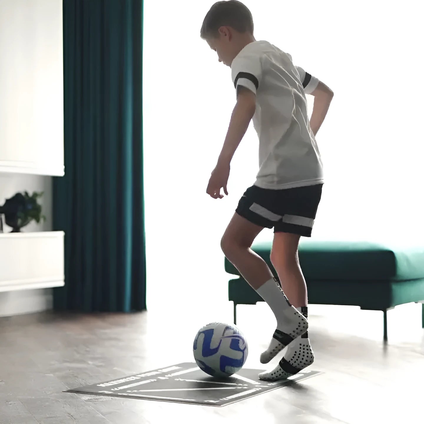 Black rectangular football training mat measuring 60cm by 90cm on a flat surface.