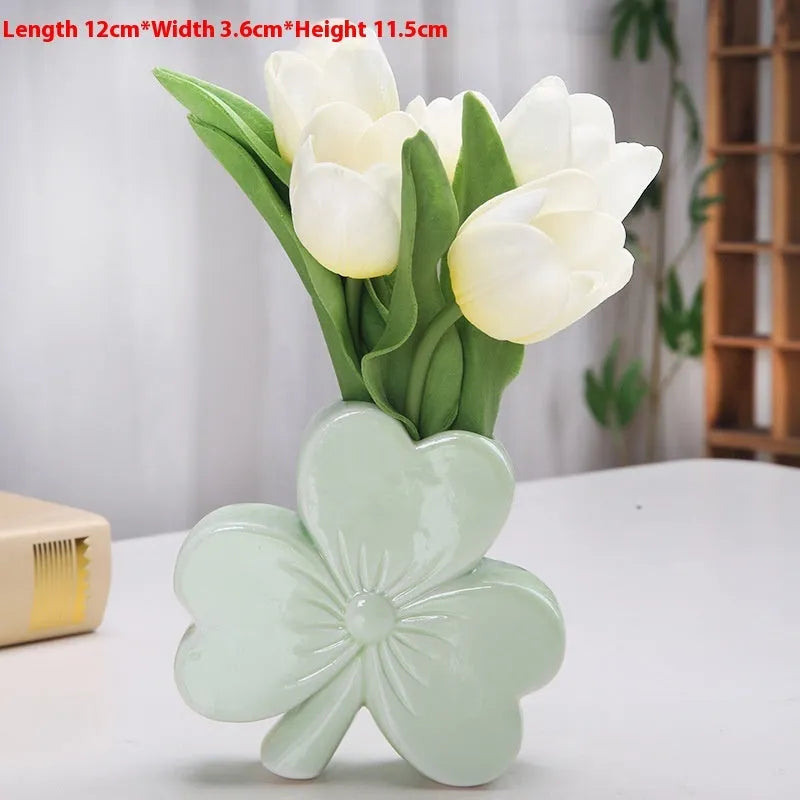 European style white porcelain ceramic vase on a desktop, shown in light green colour.