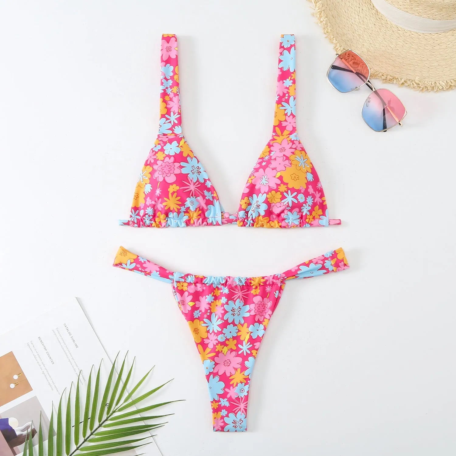 Women's blue floral print bikini top and briefs set on a white background