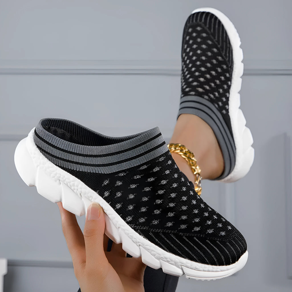 Women's black flyknit semi-slipper sock shoes with striped pattern and hollowed-out sewing lines on a lightweight sole.