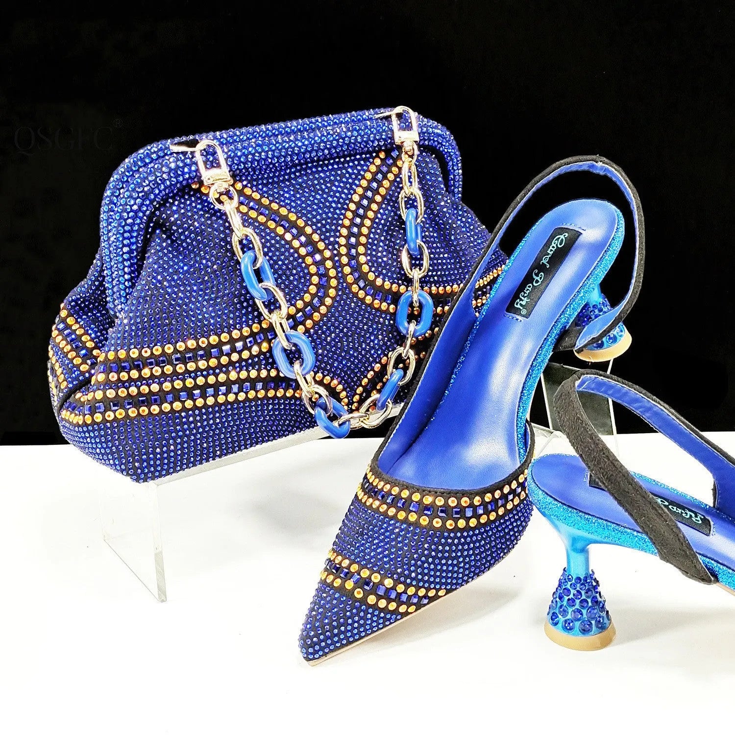Women's pointed toe high heels with rhinestones and a matching small bag, shown in one of eight available colours.