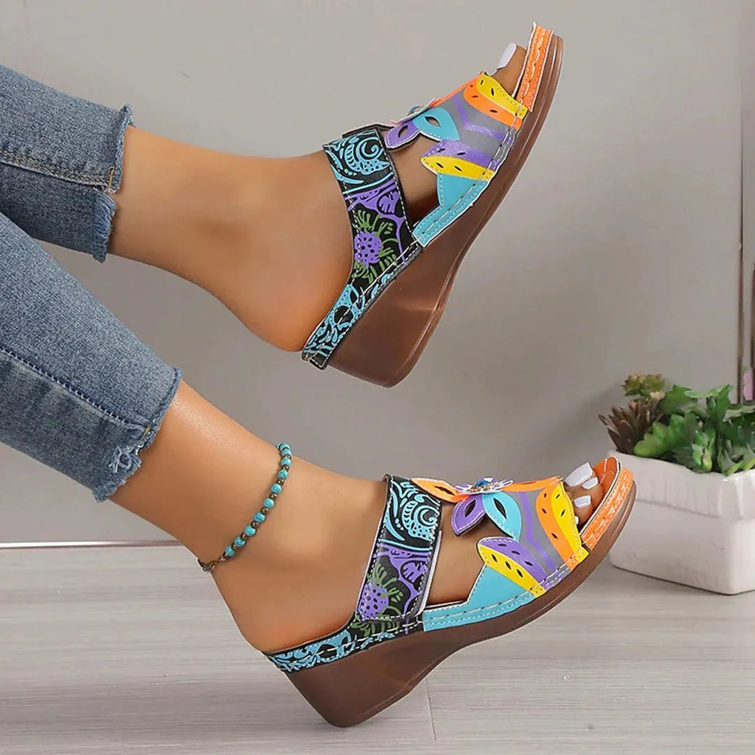 Women's ethnic patterned slippers in cowhide leather with round toe, shown in black, purple, green, and orange colours.