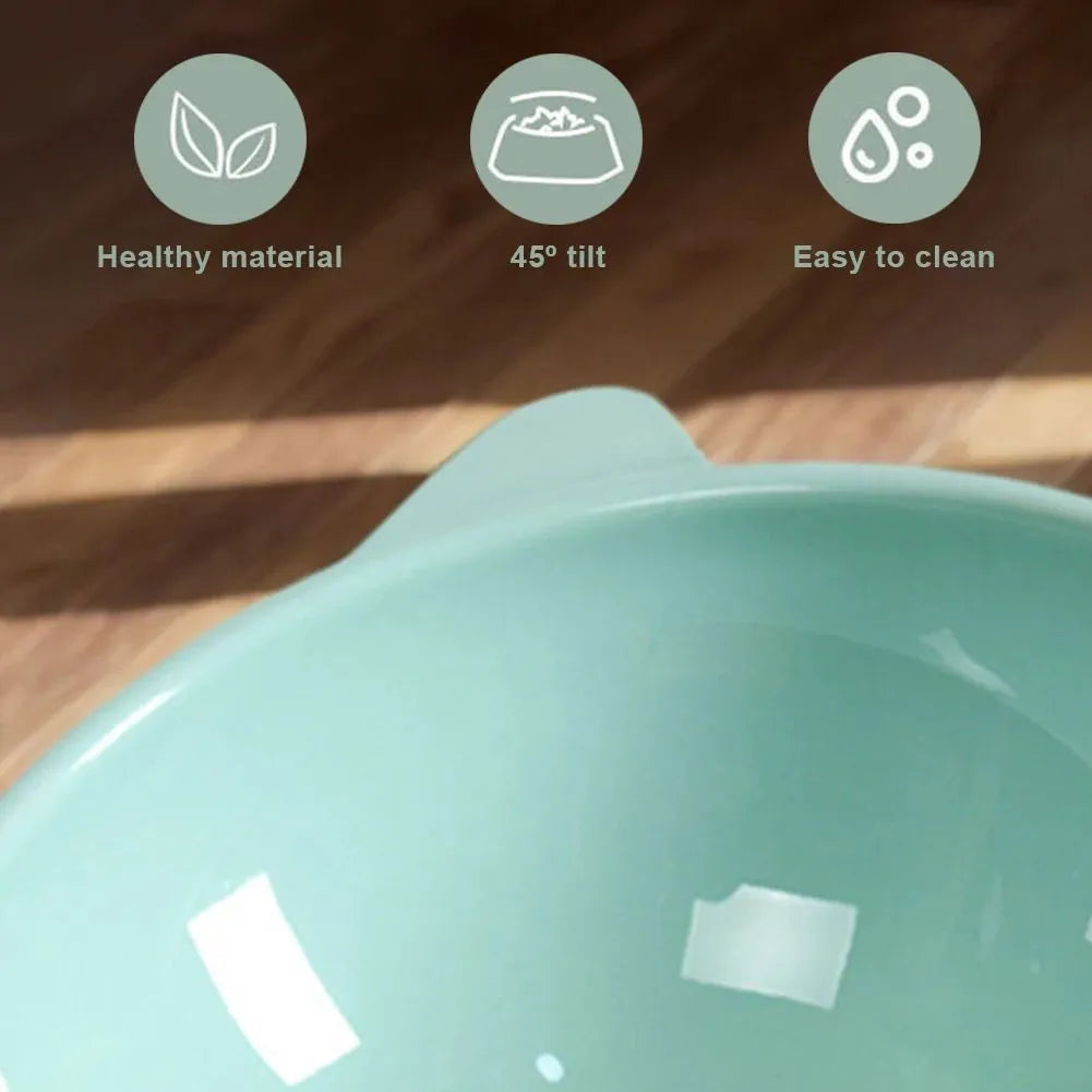 Ergonomic tilted raised plastic cat food bowl in blue with non-slip base for anti vomiting feeding