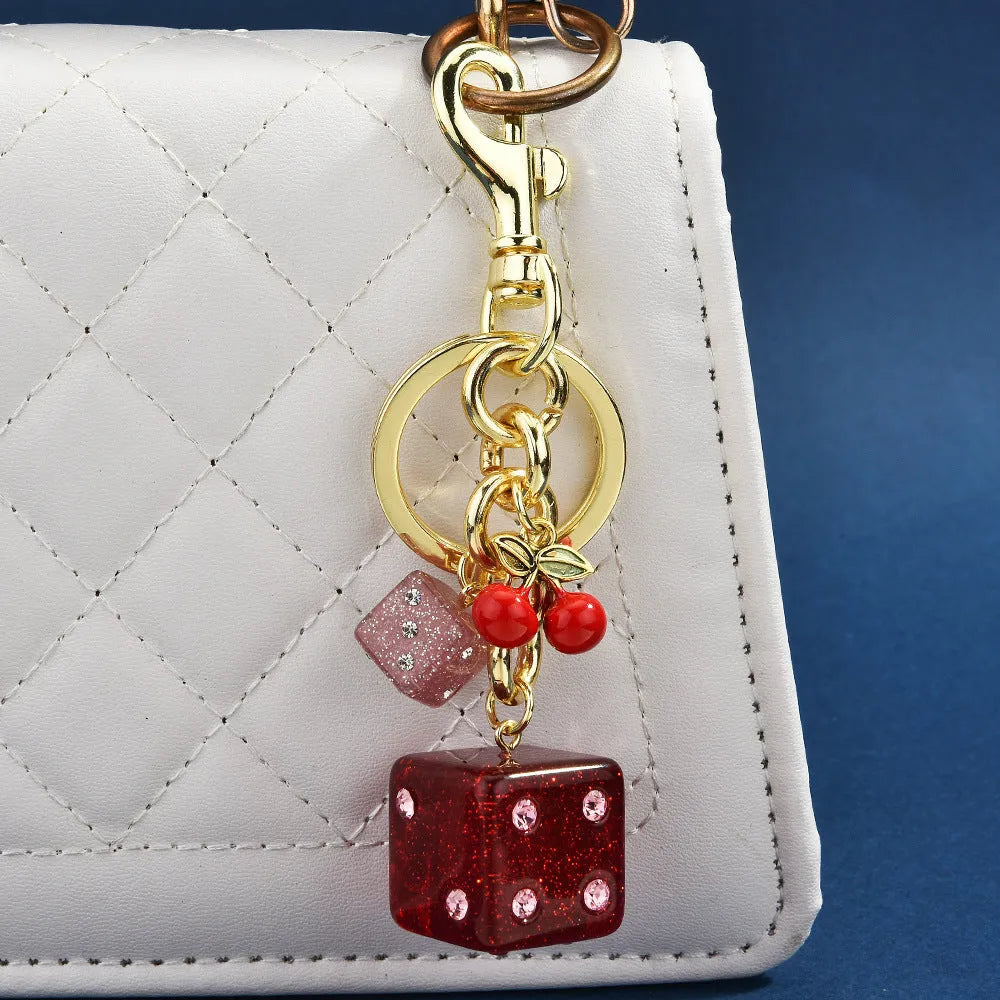 Square metal dice keychain pendant with cherry two-tone electroplated finish on a keyring