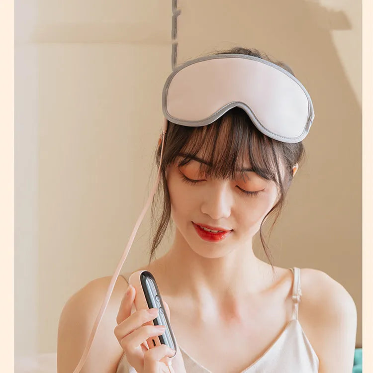 Pink and green portable steam sleep massage goggles showing suede exterior and super fibre interior.