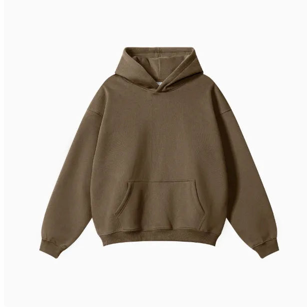 Man wearing a loose-fit grey terry cotton hooded sweater with drop-shoulder sleeves.