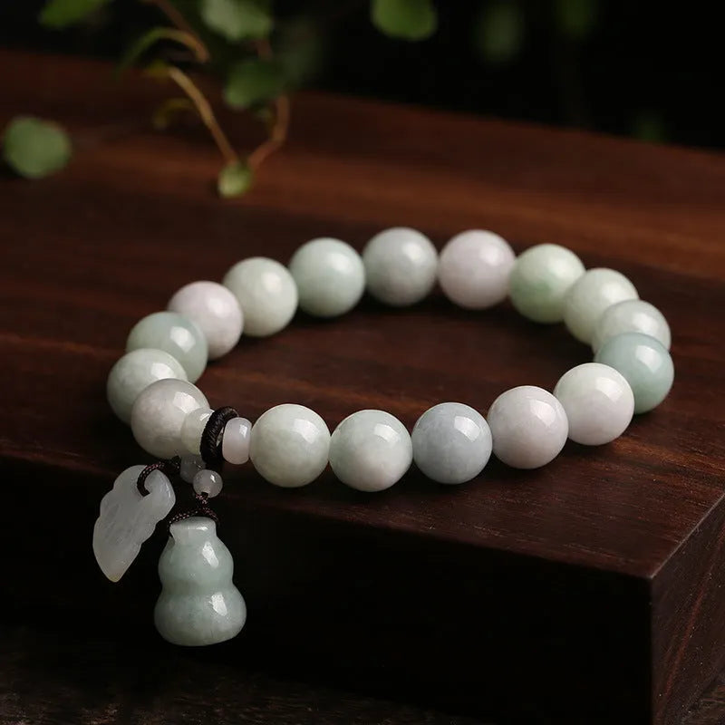 Green jade bracelet with geometric hanging beads and Maitreya Buddha charm