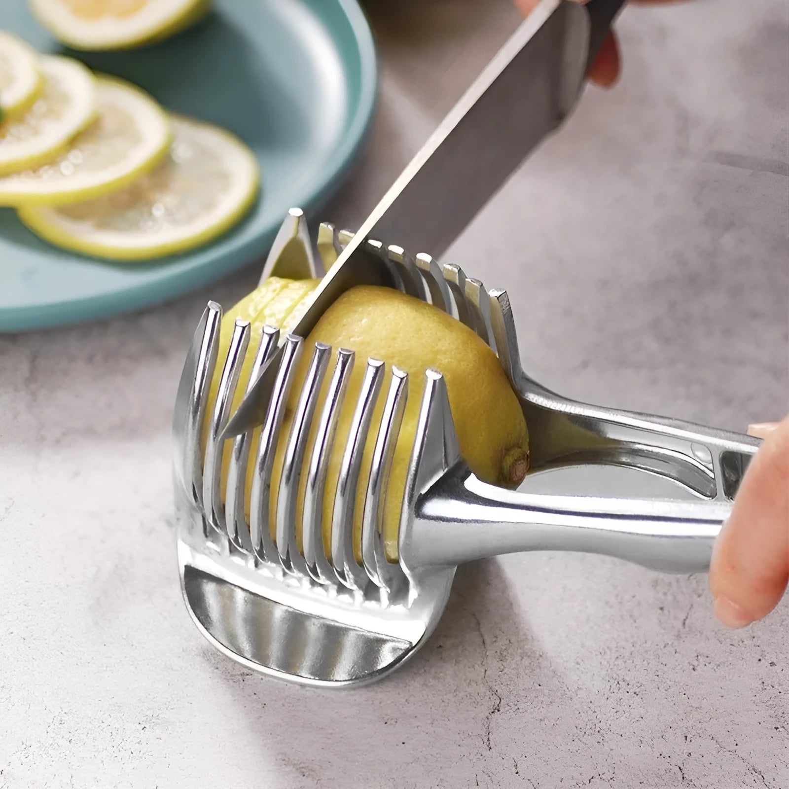 Silver plastic lemon slicer kitchen gadget on a cutting board