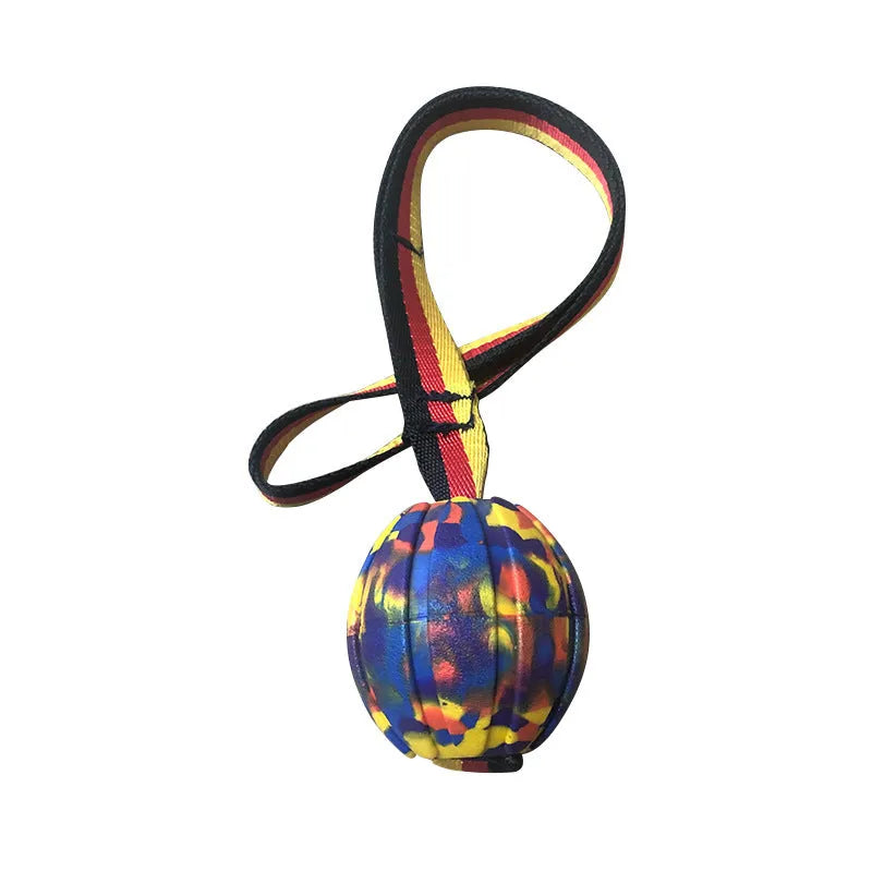 Yellow and camouflage coloured EVA foam floating dog ball with string attached for fetch and water training.