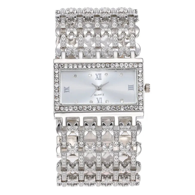 Women's steel band watch with square dial, Roman numerals, rhinestone details, and spiral crown in gold finish