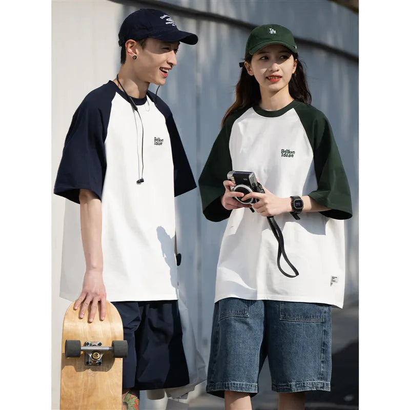 Blue loose-fit men's raglan sleeve T-shirt on a hanger, front view.