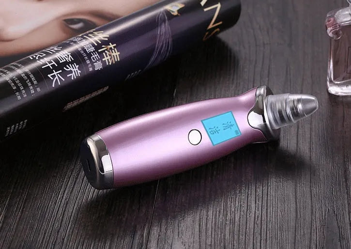 Blackhead remover pore cleaner with LCD display in ivory white on a clean surface
