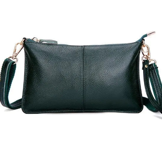 Structured cowhide lady slant bag in apricot colour with hand strap and shoulder strap, showing slim profile.
