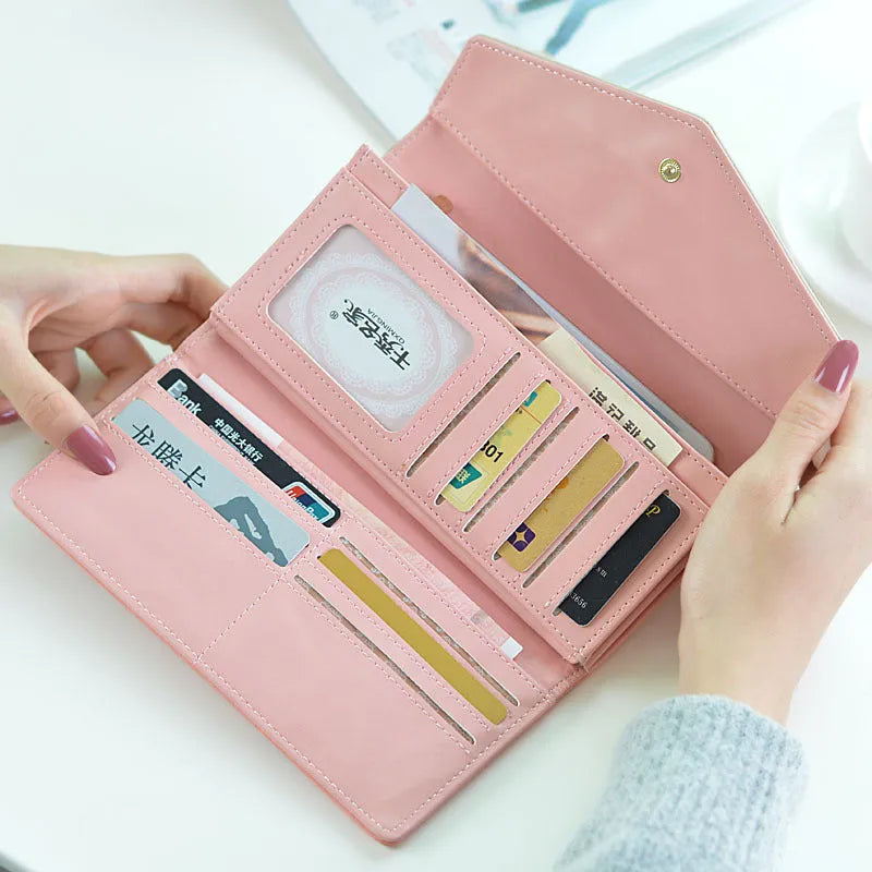 Women's three-fold leather wallet with buckle closure in black, blue, green, melon red or violet