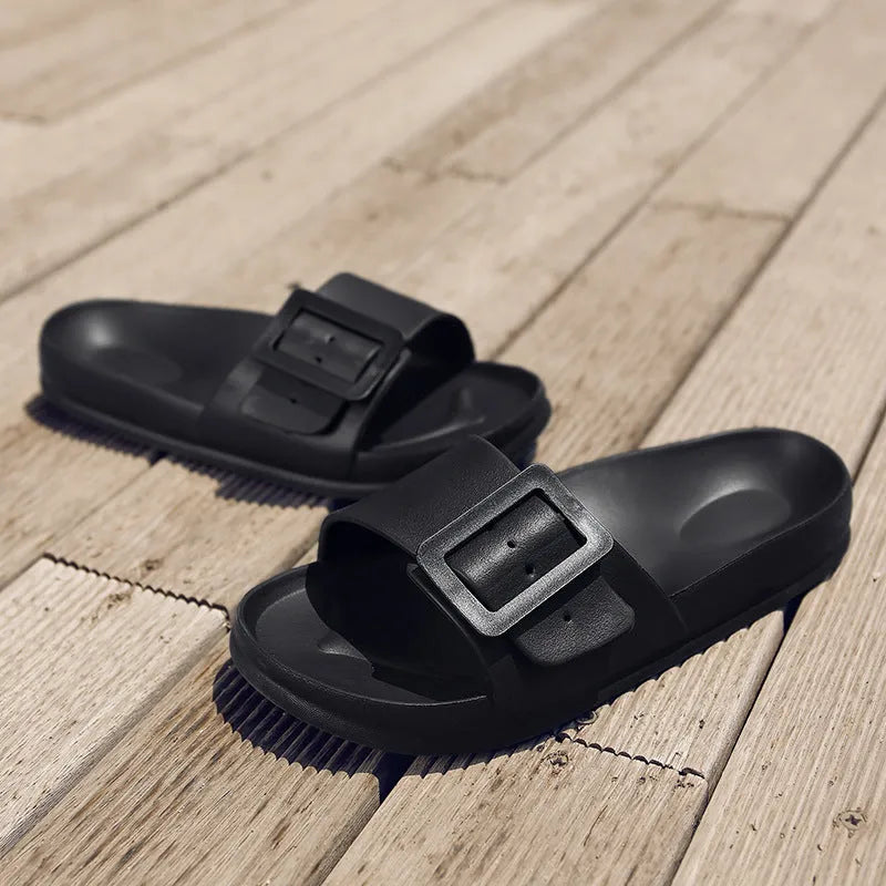 Women's grey blue buckle fastening flip-flop sandals with a soft EVA sole on a white background.