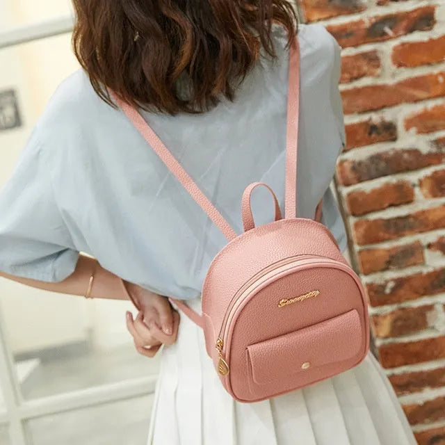 Women's small black PU backpack purse with letter design and zipper closure